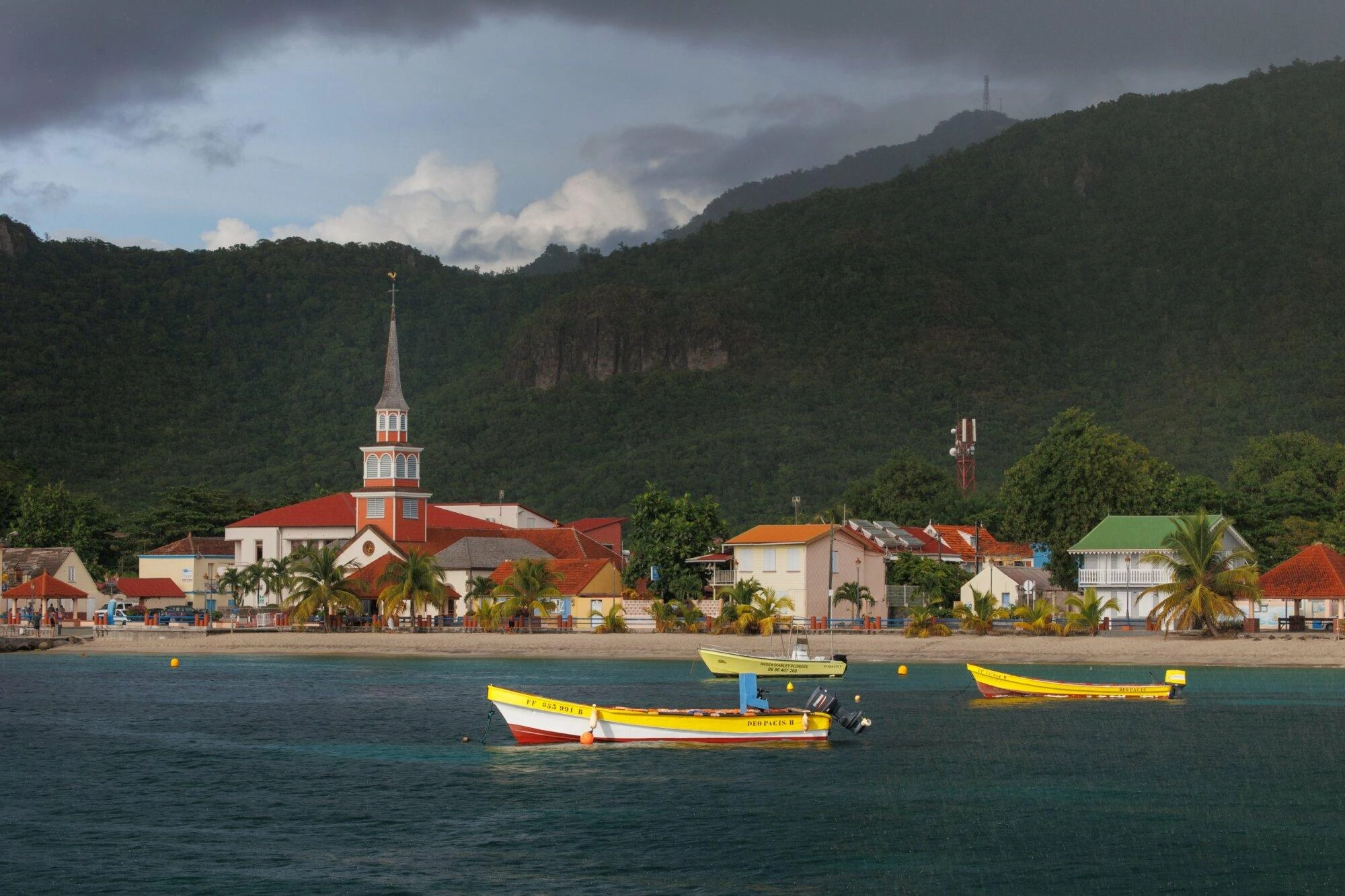 Vue de la côte depuis la mer, église locale en bord de mer et maisons d'habitation